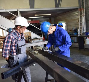 Instructor and apprentice learning how to install roofing